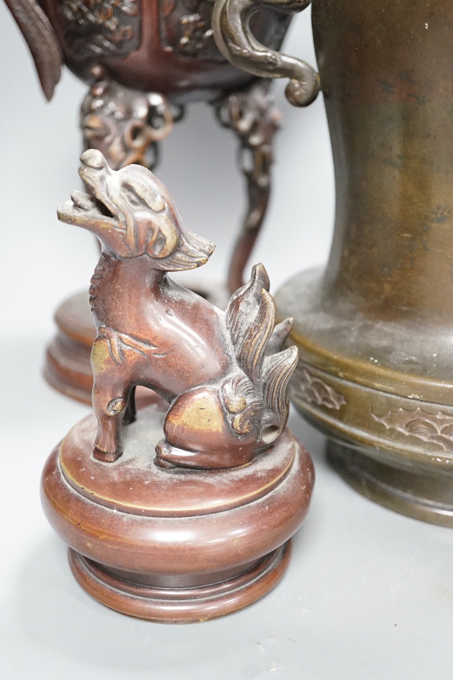 A pair of Japanese bronze vases and covers, 41 cm high and a Japanese two handled vase, 26 cm high, all Meiji period